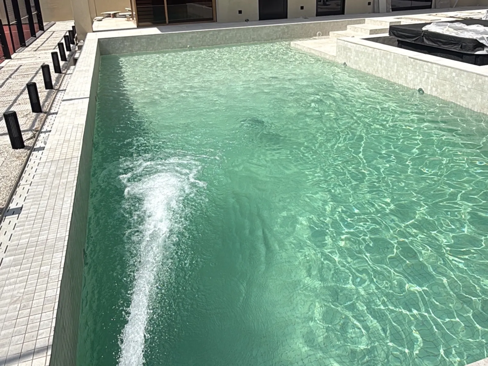 Sweet water from a WaterLink tanker hose filling a villa swimming pool in Dubai